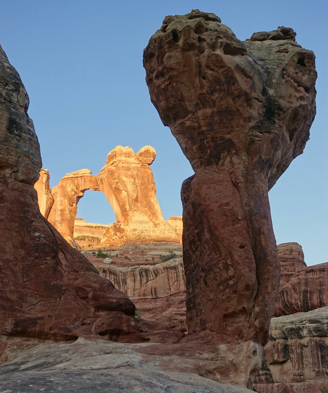 Sunrise on Angel Arch and Molar Rock in Salt Creek canyon hike in Canyonlands National Park, Utah