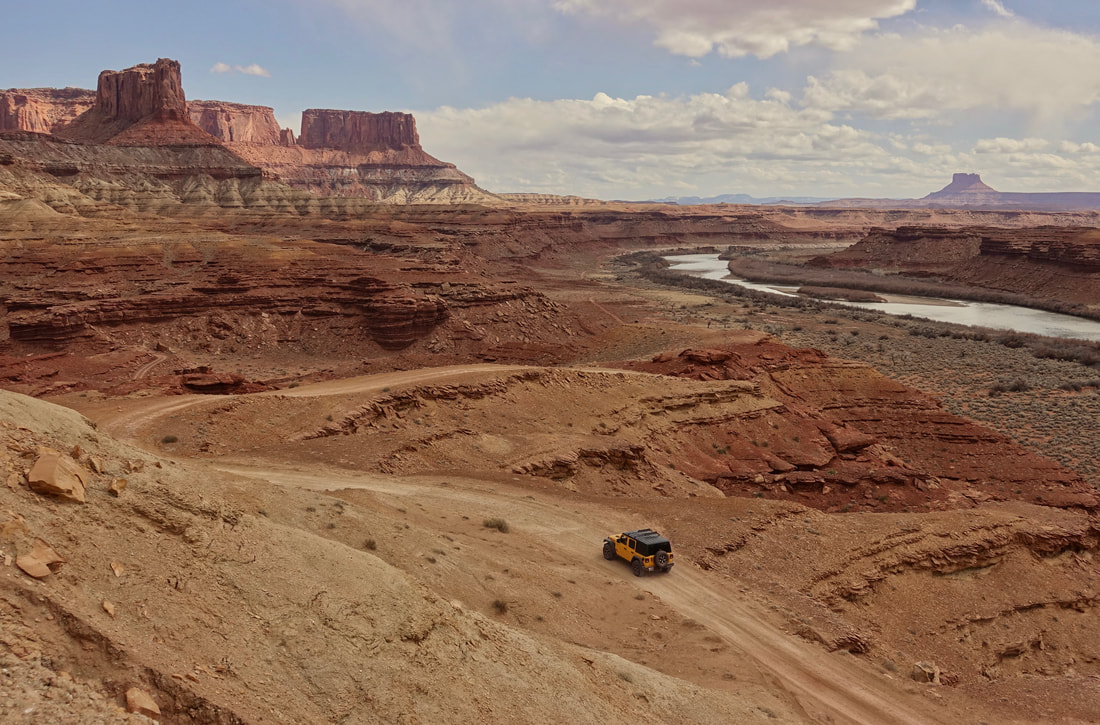 Jeep driving on the White Rim Road in Canyonlands