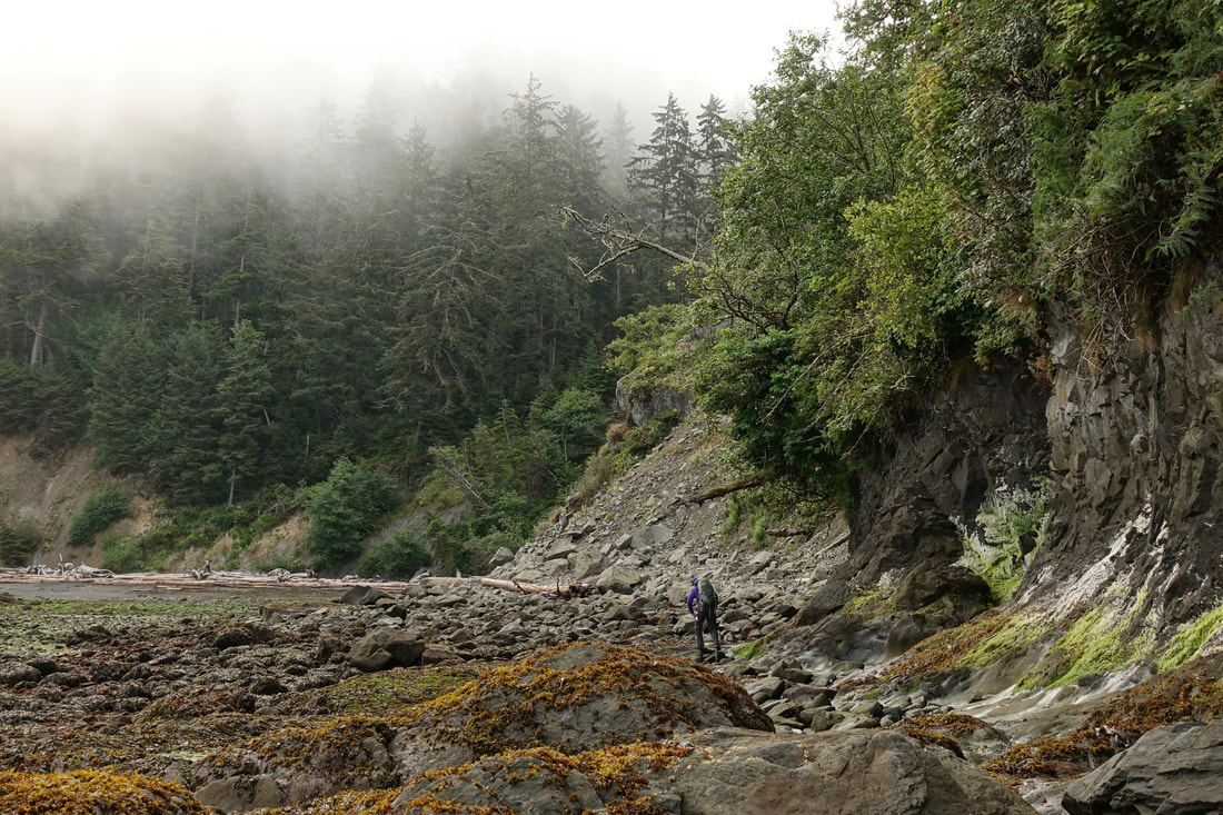 Rock hopping on a backpacking trip along the Olympic coastline in the national park