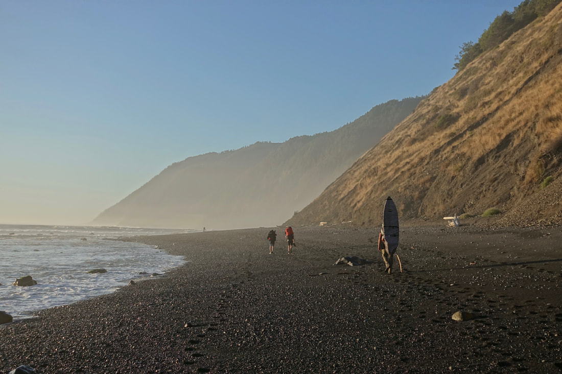 Surfers making the walk to Big Flat on the Lost Coast